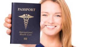 A foreign nurse holds up her passport.