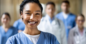 smiling nurse standing in group